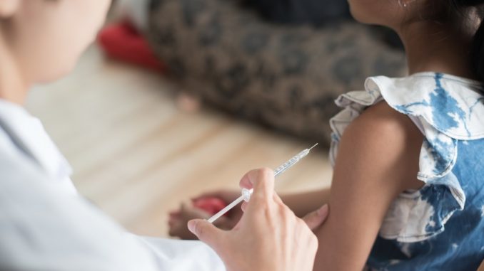 Close up of doctor vaccinating young girl, Vaccination concept.